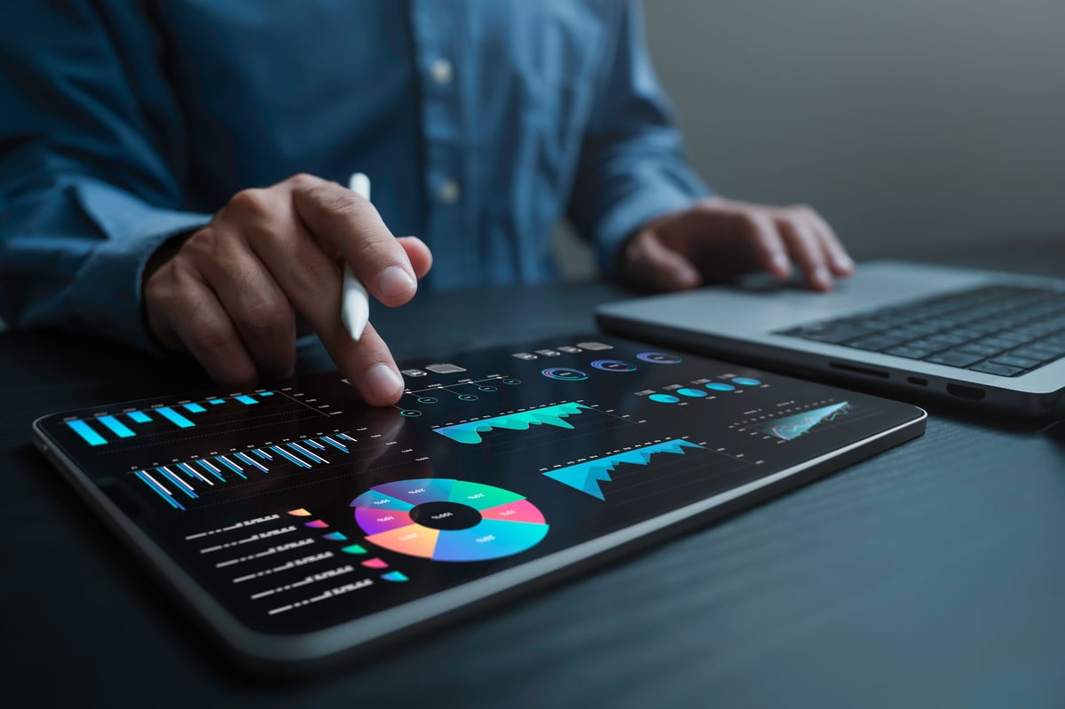 Analyst using business data dashboard with KPIs and metrics